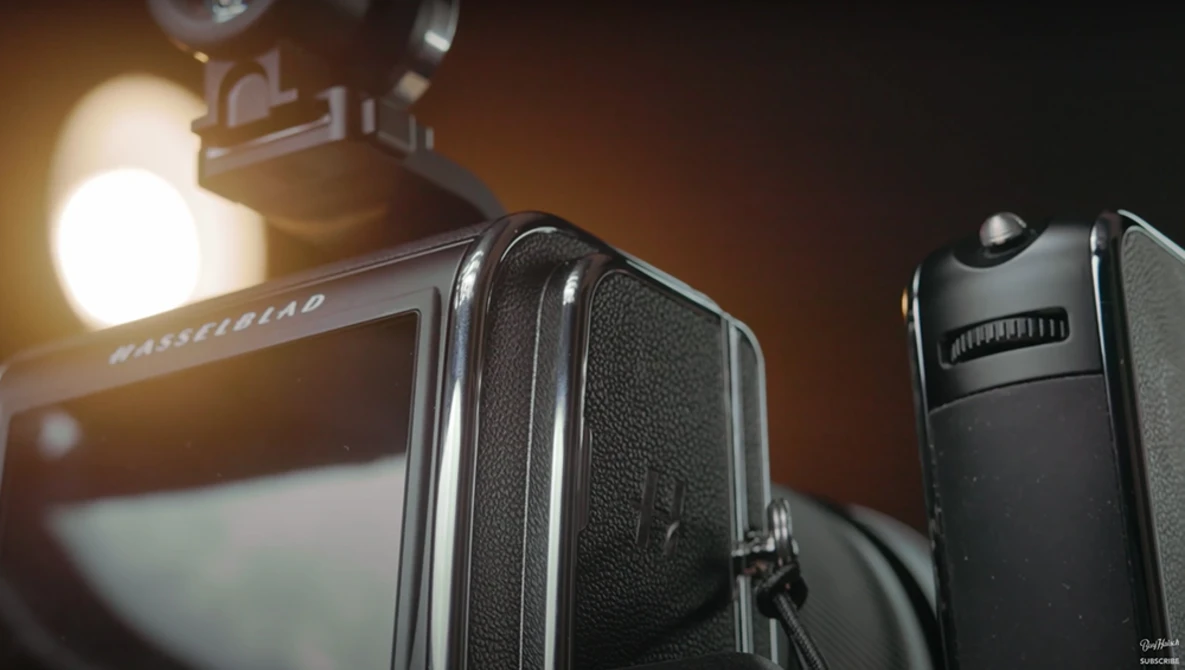 Medium format camera with textured leather body and bright studio light in background.