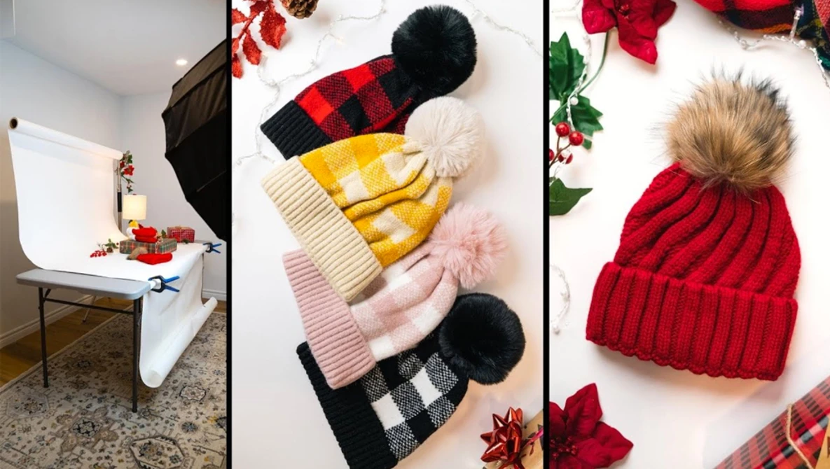 Product photography setup showing winter beanies with pom-poms and holiday decorations arranged on white surface.