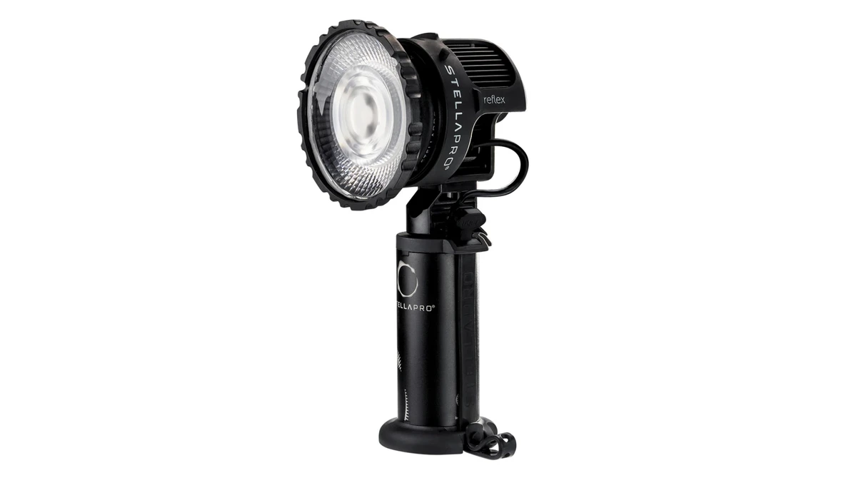 Professional LED spotlight with fresnel lens mounted on adjustable stand with handle.