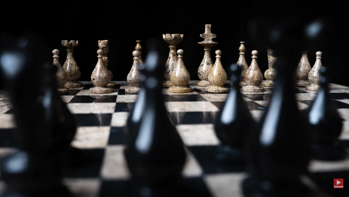 Chess pieces arranged on a board with selective focus and shallow depth of field.