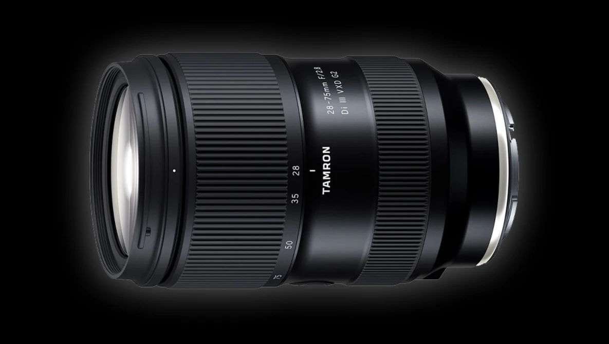 Tamron zoom lens with black barrel and white text markings shown against a dark background.