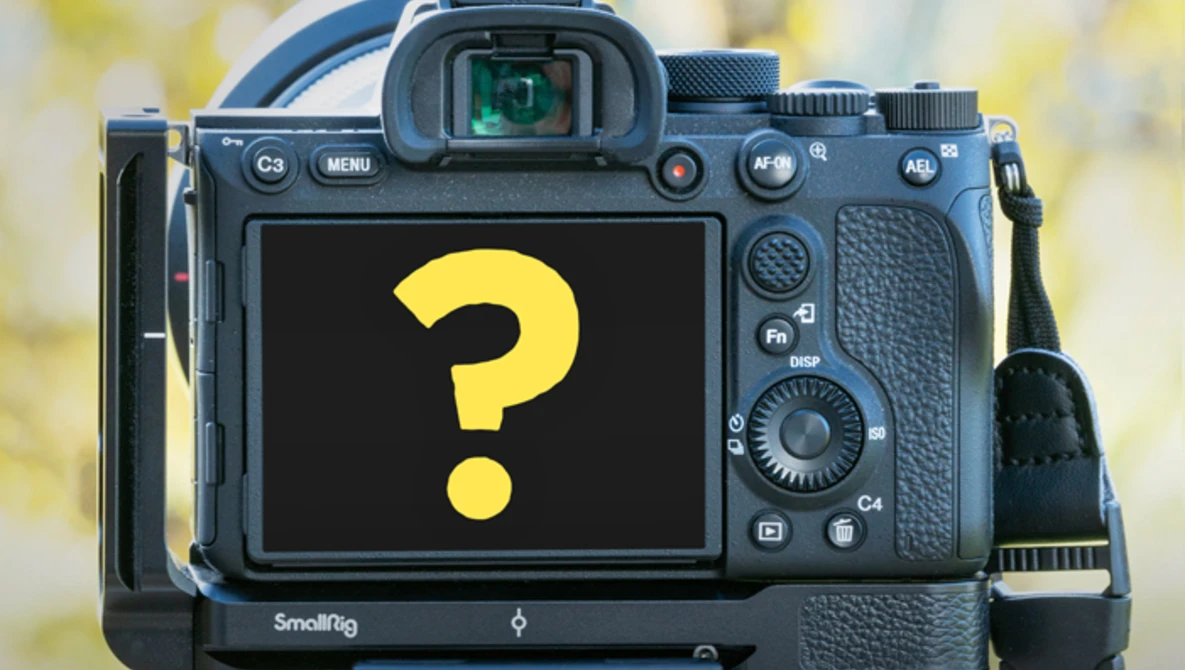 Professional mirrorless camera with SmallRig cage displaying a yellow question mark on its LCD screen.