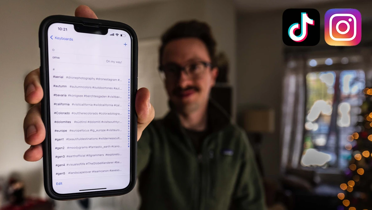Smartphone displaying a social media feed with multiple posts, held by a person wearing glasses indoors.