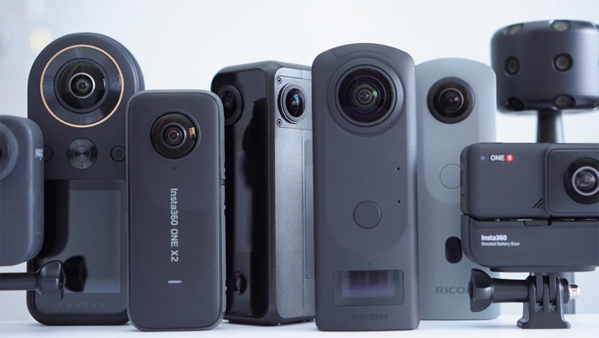 Collection of compact video cameras and action cameras arranged in a line against a white background.