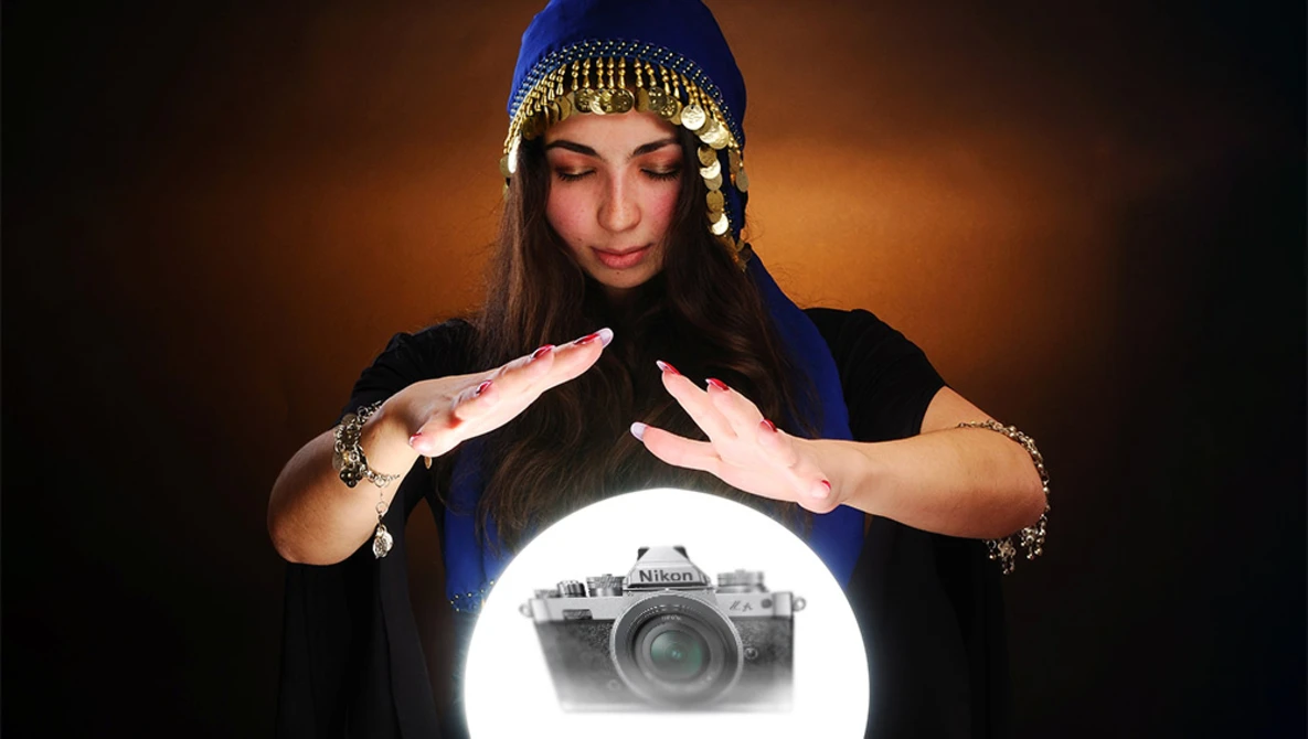 Woman with hands framing glowing camera illustration against warm background.