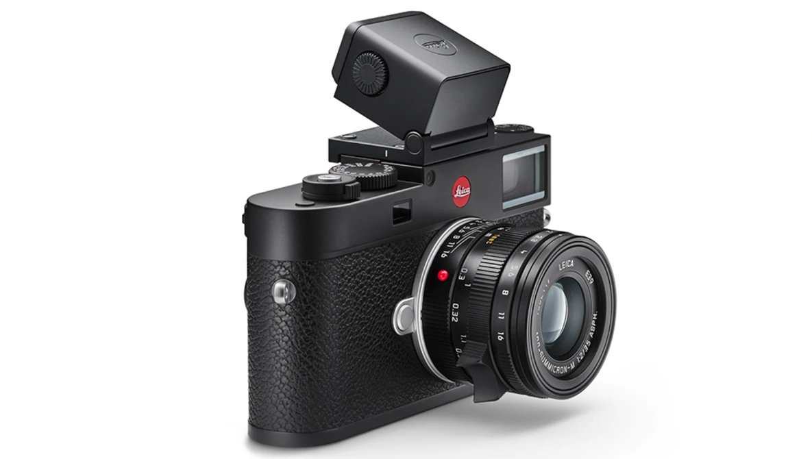 Leica M rangefinder camera with mounted flash and external viewfinder accessory.