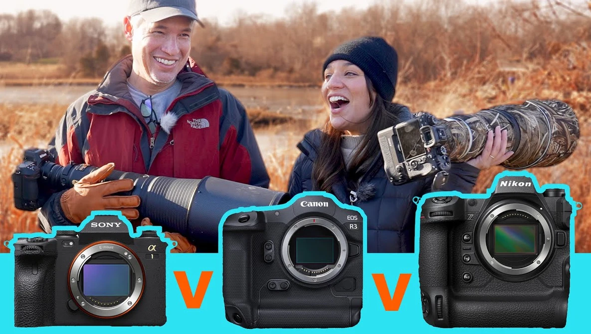Two photographers outdoors holding telephoto lenses with three camera bodies displayed below them.