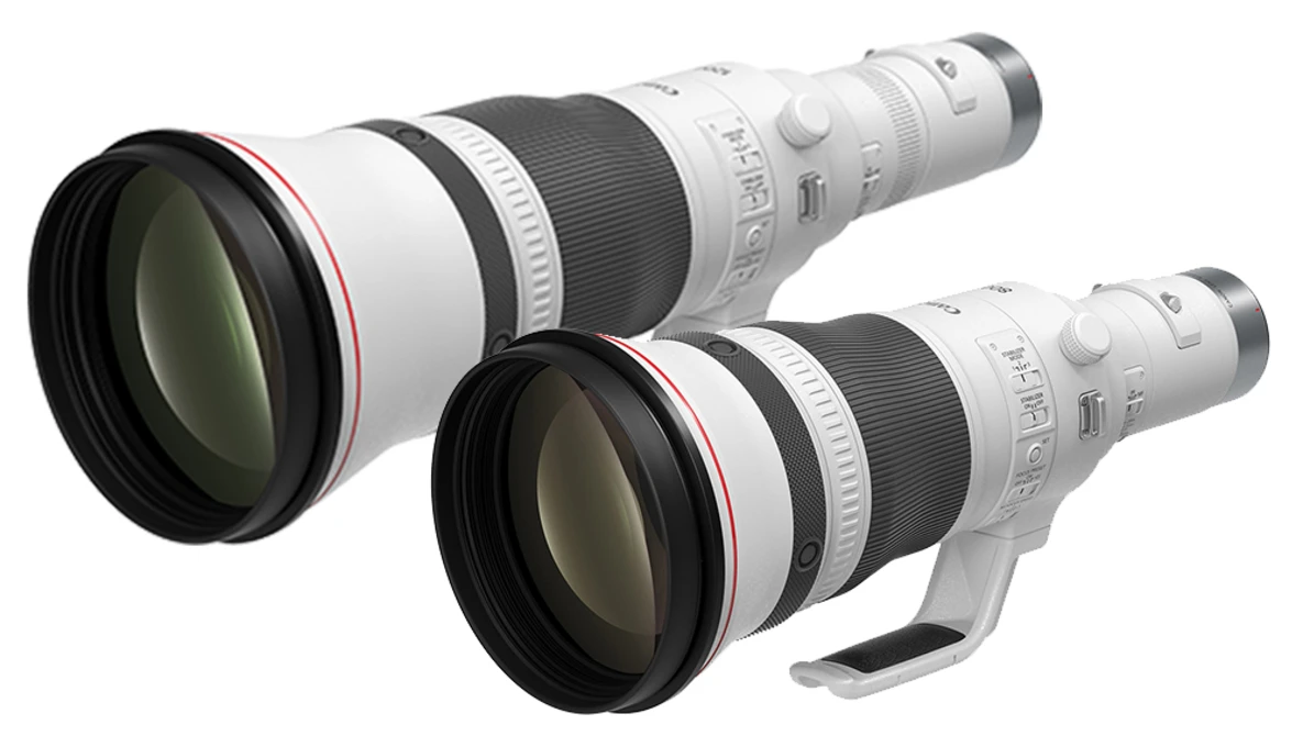 Two white telephoto lenses with black barrels and front elements arranged side by side.