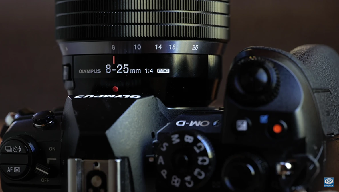 Olympus 8-25mm f/1.4 Pro lens mounted on a mirrorless camera body with manual focus ring visible.