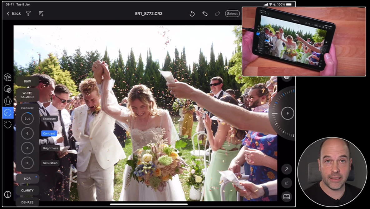 Wedding ceremony with bride and groom raising hands as guests celebrate outdoors under evergreen trees.