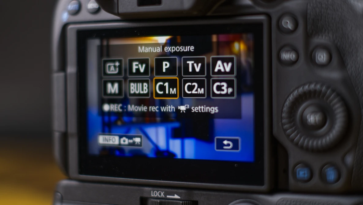 Screenshot of a camera's manual exposure mode menu displaying exposure compensation options and custom function settings.