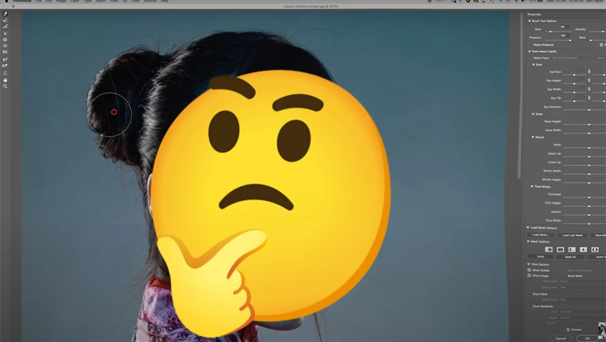 Woman with dark hair holding an oversized yellow emoji face with furrowed brows and hand to chin, conveying a confused or thoughtful expression.