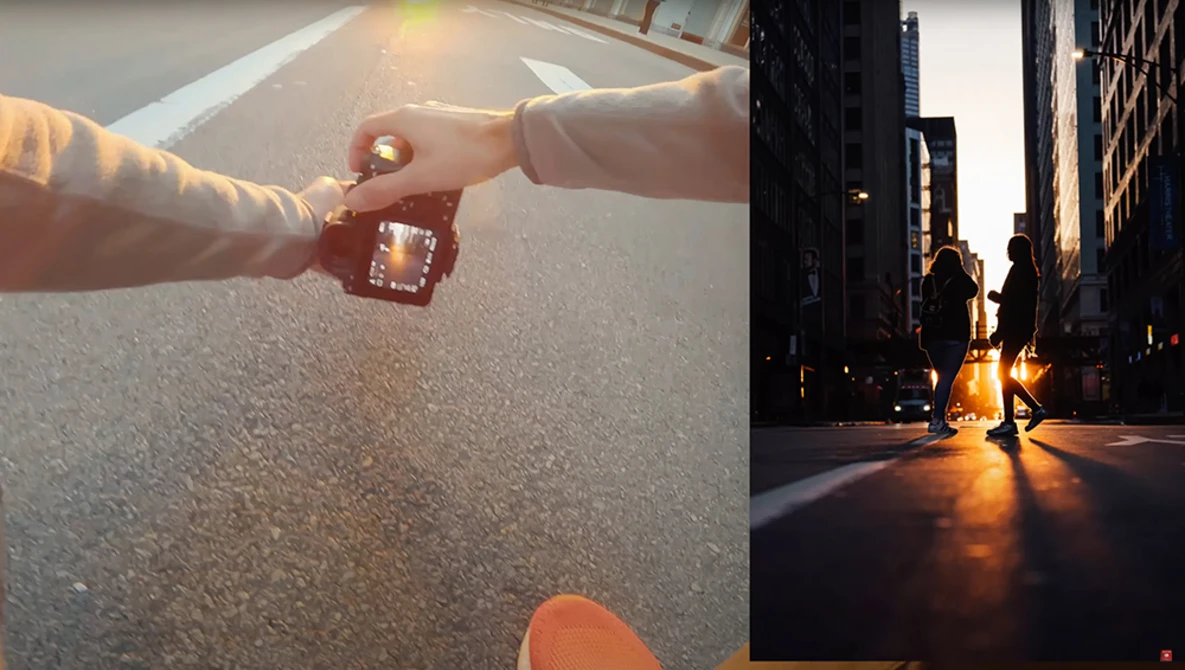 Two hands exchanging a small decorative object on an asphalt surface during golden hour.
