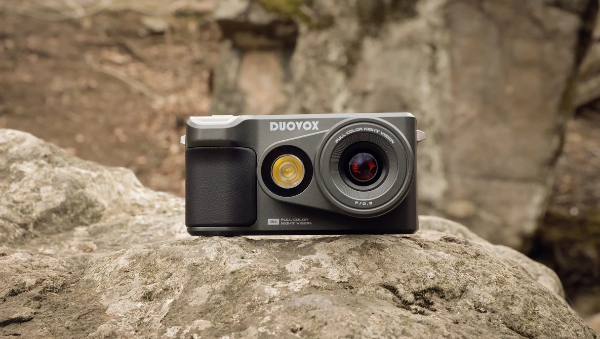Duoyox instant camera with dual lenses positioned on a textured stone surface.