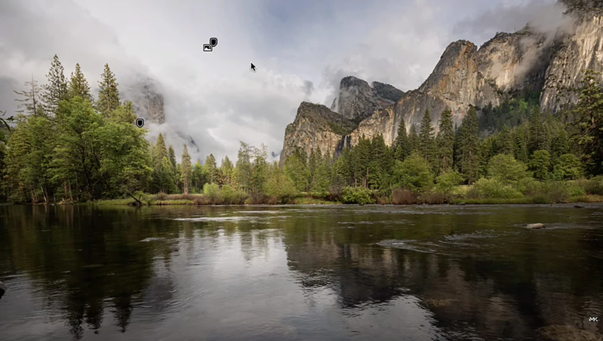 Granite cliffs rise above a calm river lined with coniferous forest, partially shrouded in mist under overcast sky.