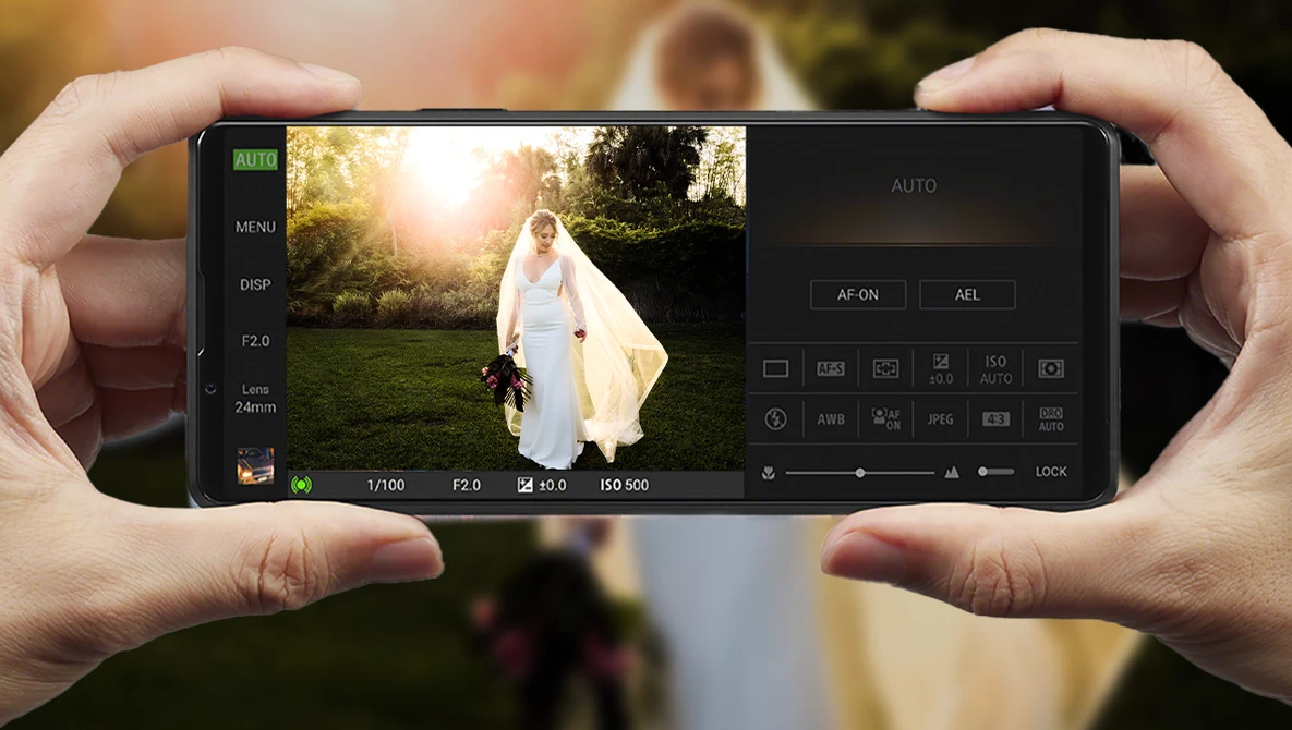 Screenshot of a smartphone camera app displaying a bride in a white gown outdoors with golden hour lighting.