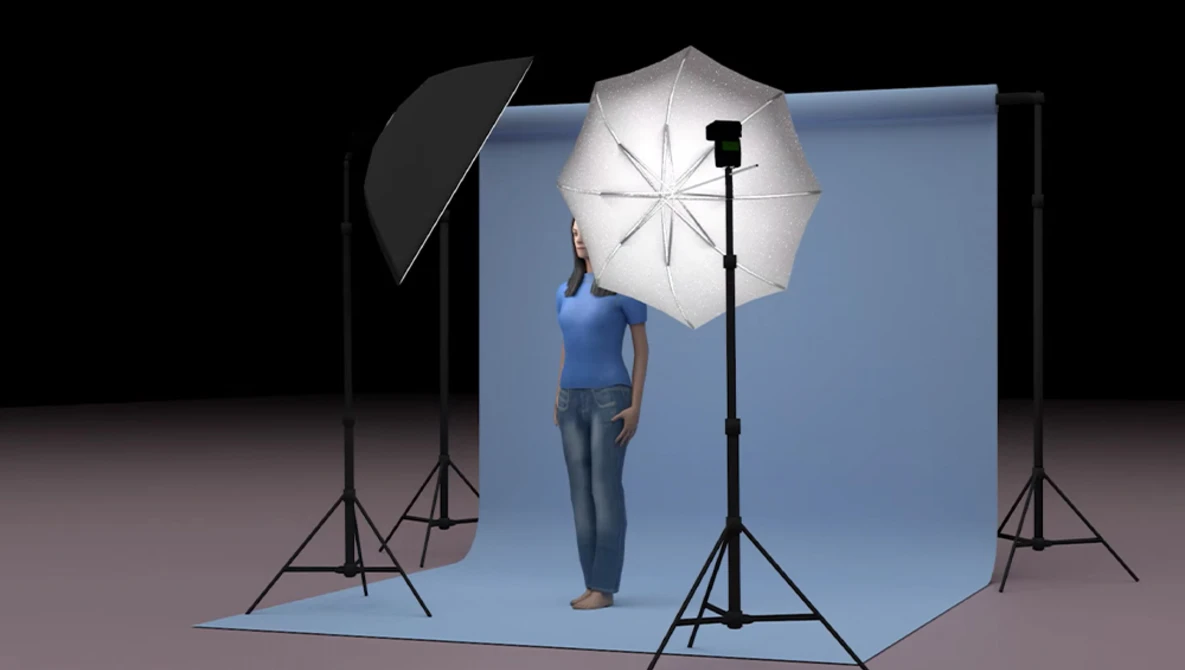 Portrait studio setup with model holding reflective umbrella under key light on seamless backdrop.