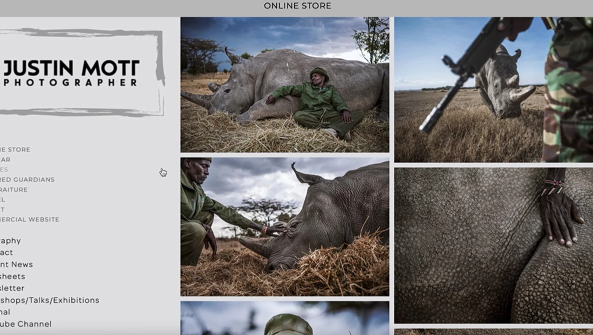 Wildlife photographer documenting close-up details of a rhinoceros in natural habitat.