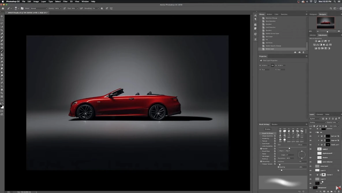 Red convertible sports car photographed in profile against a dark gradient studio background.