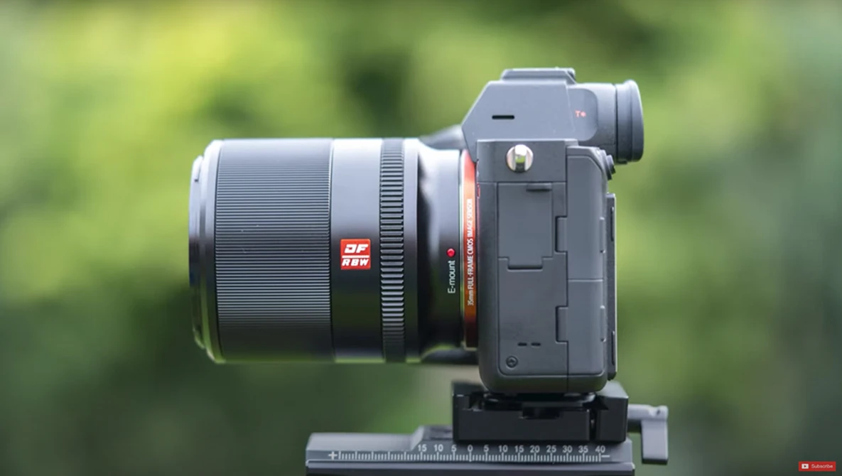 Sony mirrorless camera with telephoto lens mounted on a measurement scale.