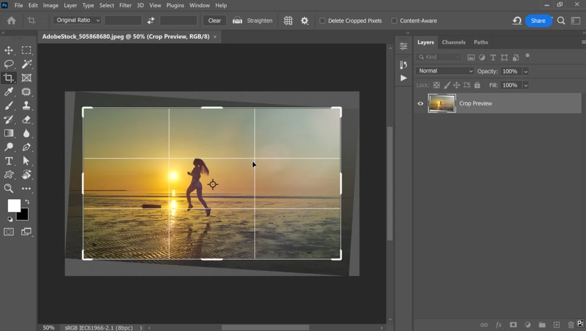 Screenshot of Adobe Photoshop displaying a golden hour beach photograph with crop guides overlaid.