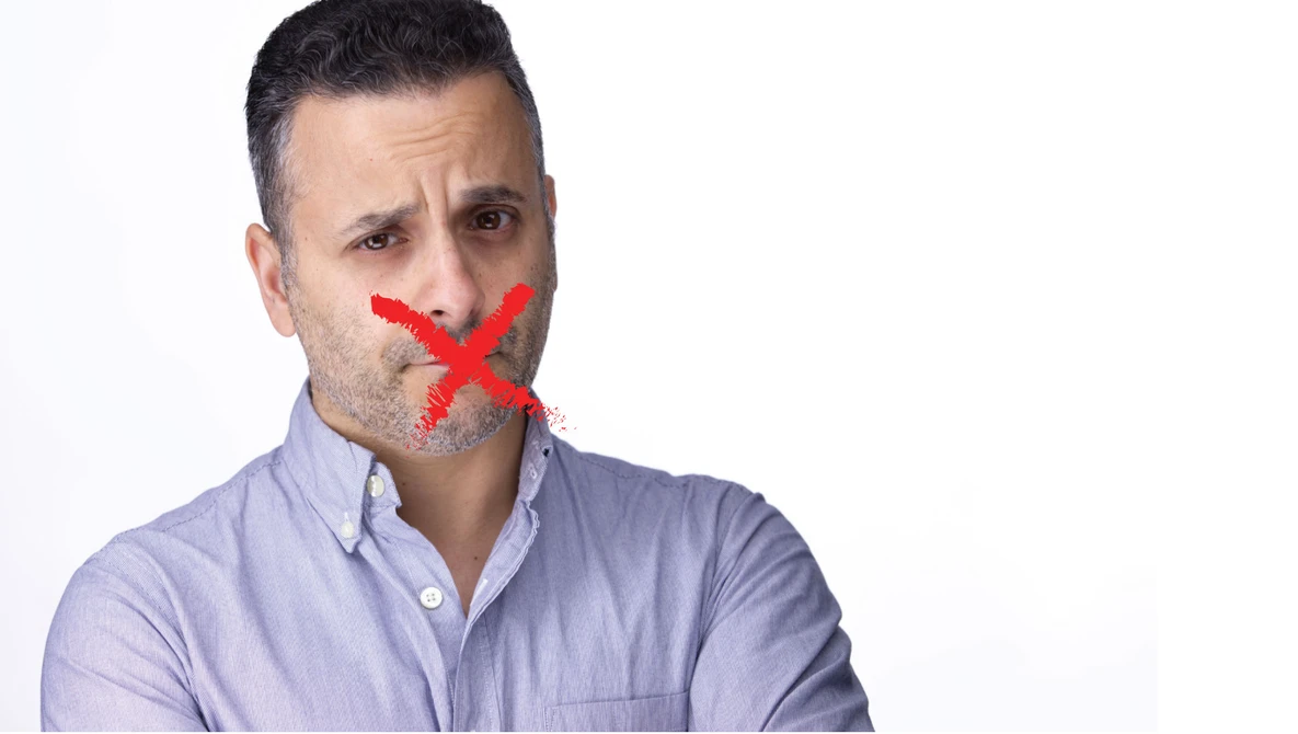 Man with red X marked across his mouth against white background.
