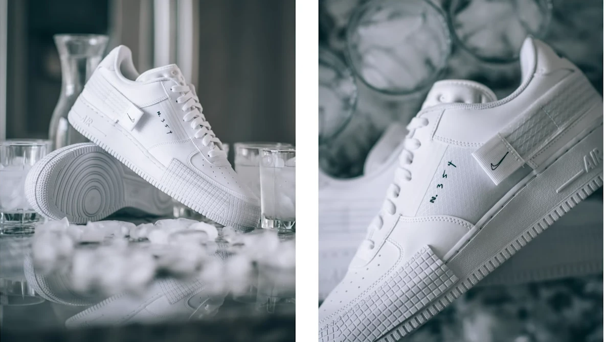 Two white sneakers photographed from different angles against a minimalist backdrop with glasses and ice.