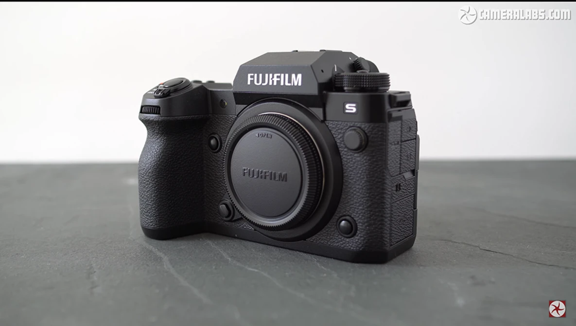 Fujifilm S mirrorless camera body shown from front-center angle against neutral gray background.