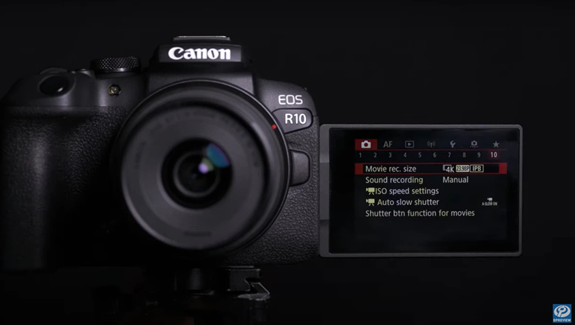 Canon EOS R10 mirrorless camera displayed against a black background with rear LCD screen showing menu options.