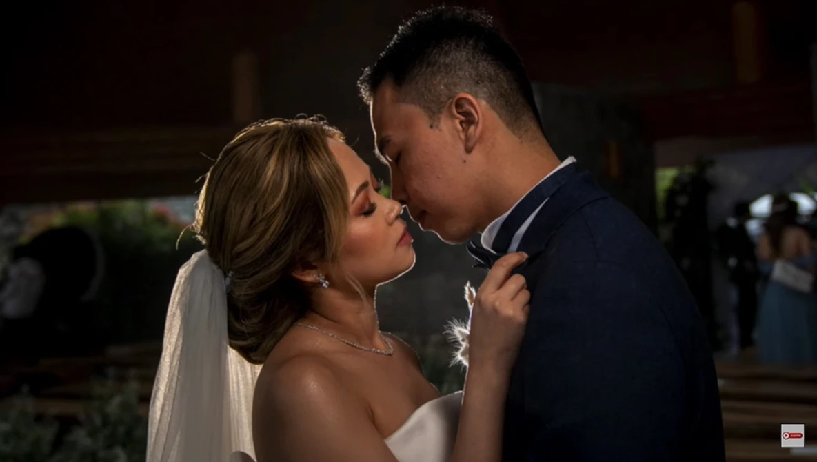 Bride and groom sharing an intimate moment during their first dance at night.