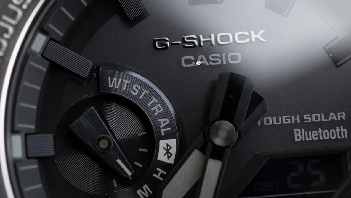 Close-up detail of a G-Shock Casio watch face showing Tough Solar and Bluetooth features.