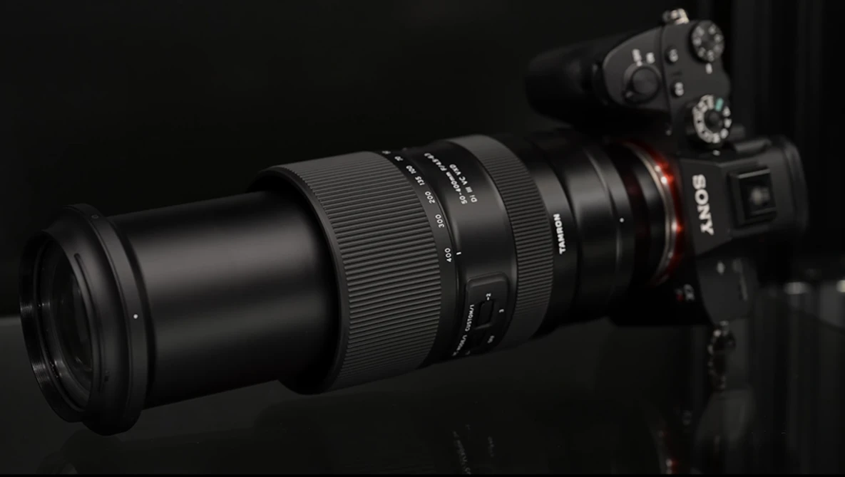 Sony mirrorless camera with telephoto lens mounted, photographed against a dark background.