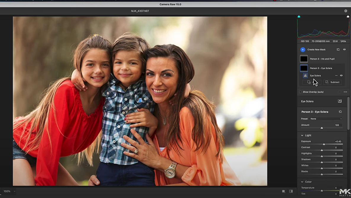 Three women and a young child posing together outdoors with warm, natural backlighting.