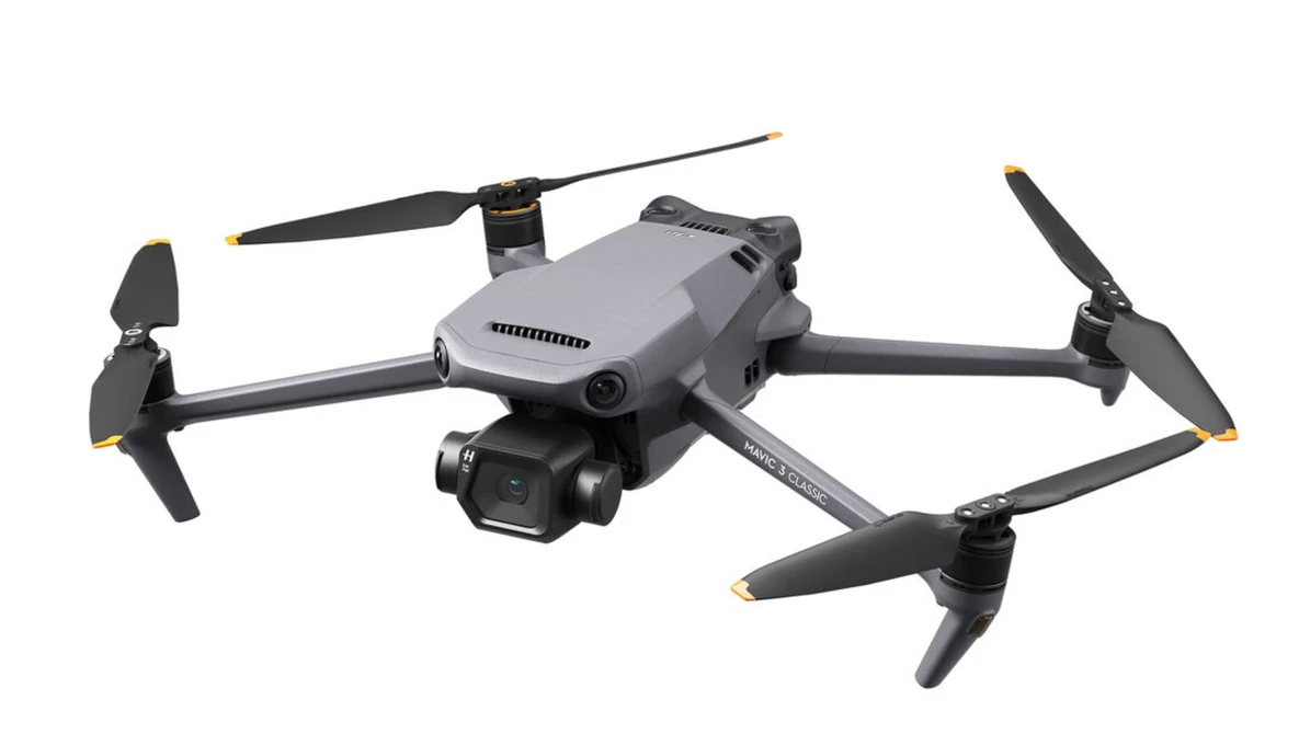 Gray and black quadcopter drone with folded arms shown against a white background.