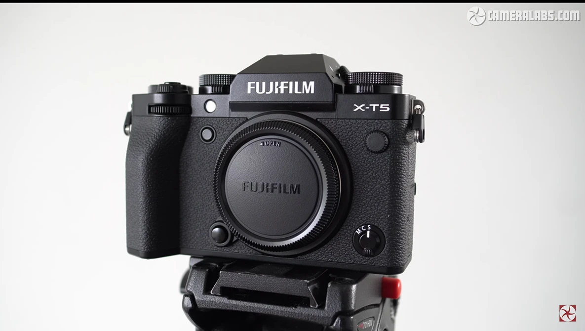 Fujifilm X-T5 mirrorless camera body mounted on a tripod plate, front view.