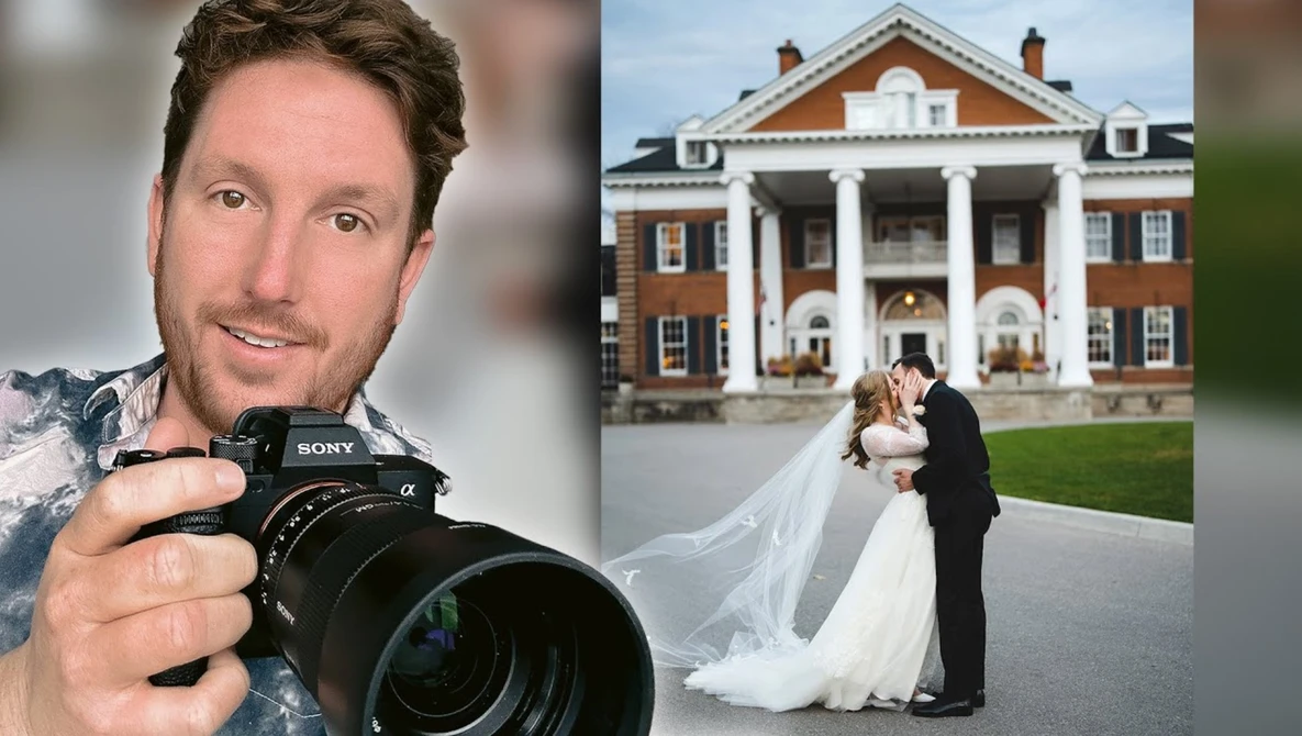 Professional photographer holding Sony mirrorless camera with telephoto lens, smiling at camera.