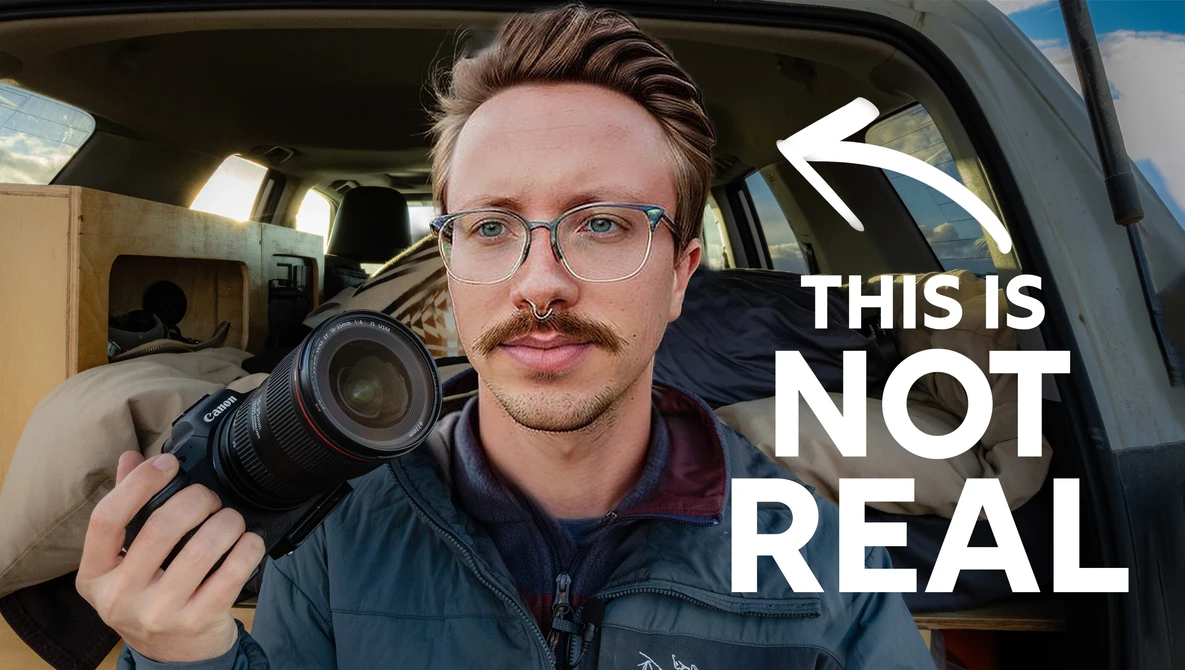 Photographer holding a DSLR camera inside a van, wearing glasses and a puffy jacket.