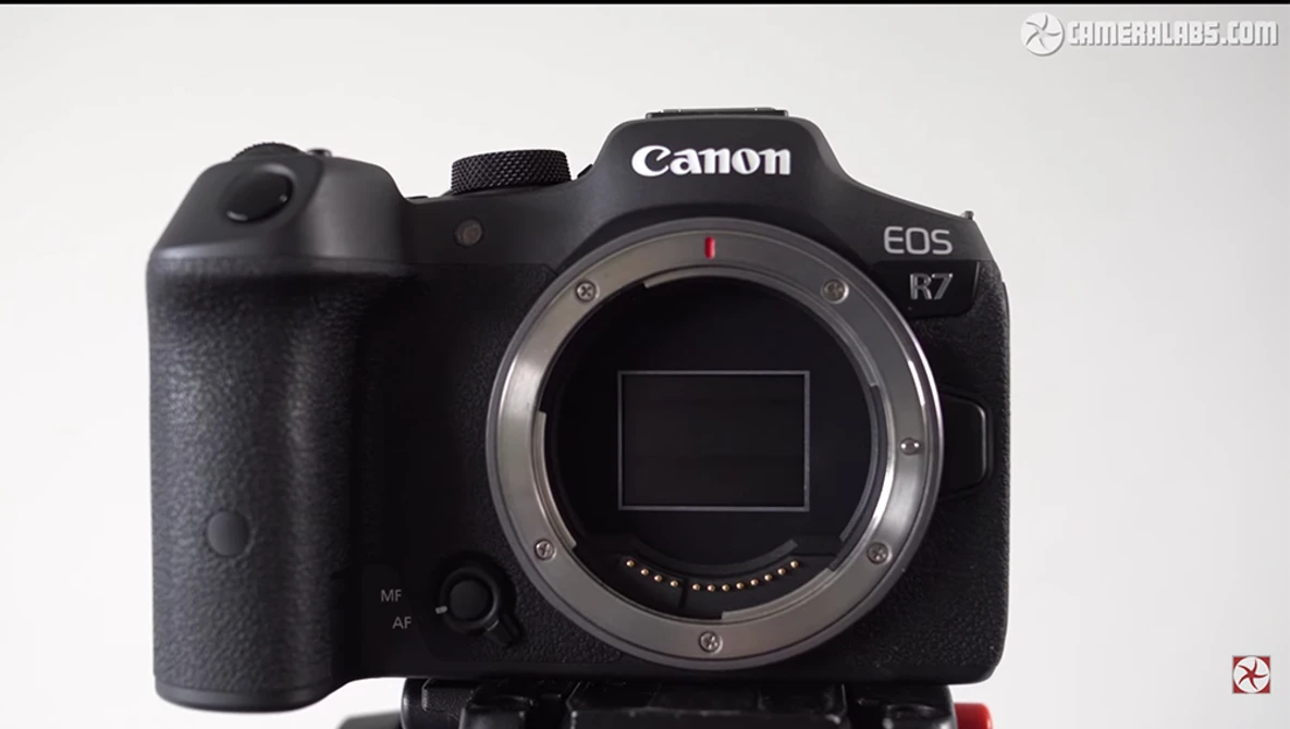 Canon EOS R7 mirrorless camera body shown from front with lens mount exposed.