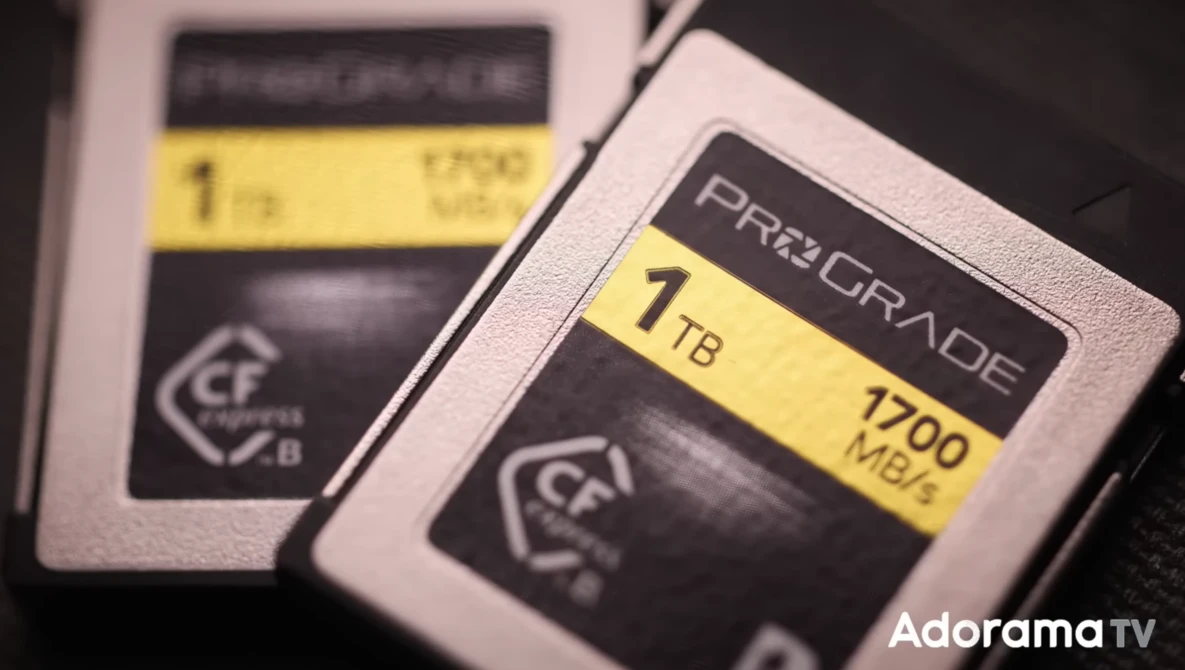 Two CompactFlash memory cards with 1TB capacity labels displayed side by side.
