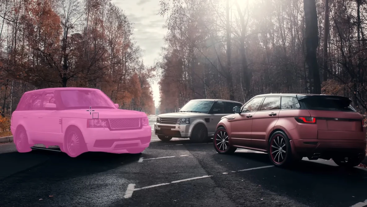 Three SUVs parked on a tree-lined road; the leftmost vehicle is rendered in bright pink while the other two are photorealistic.