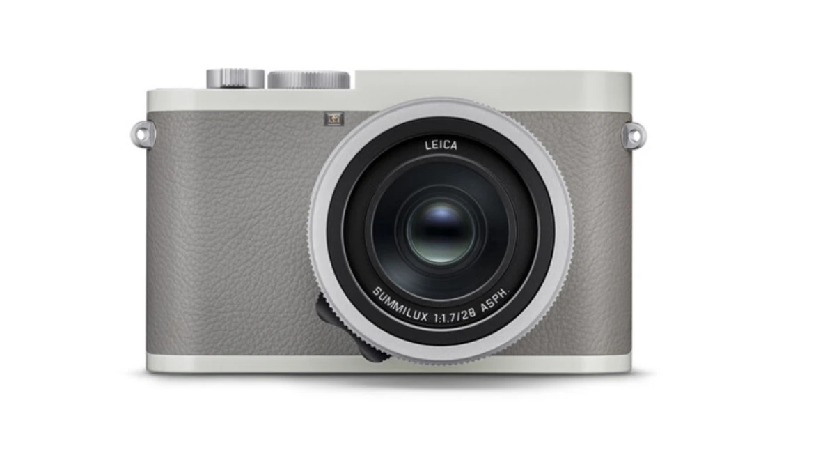 Leica Q2 digital camera with gray leather body and silver top plate, shown from front against white background.