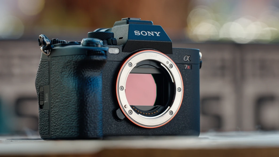 Sony a7 III mirrorless camera body with lens mount exposed, shown against blurred architectural background.