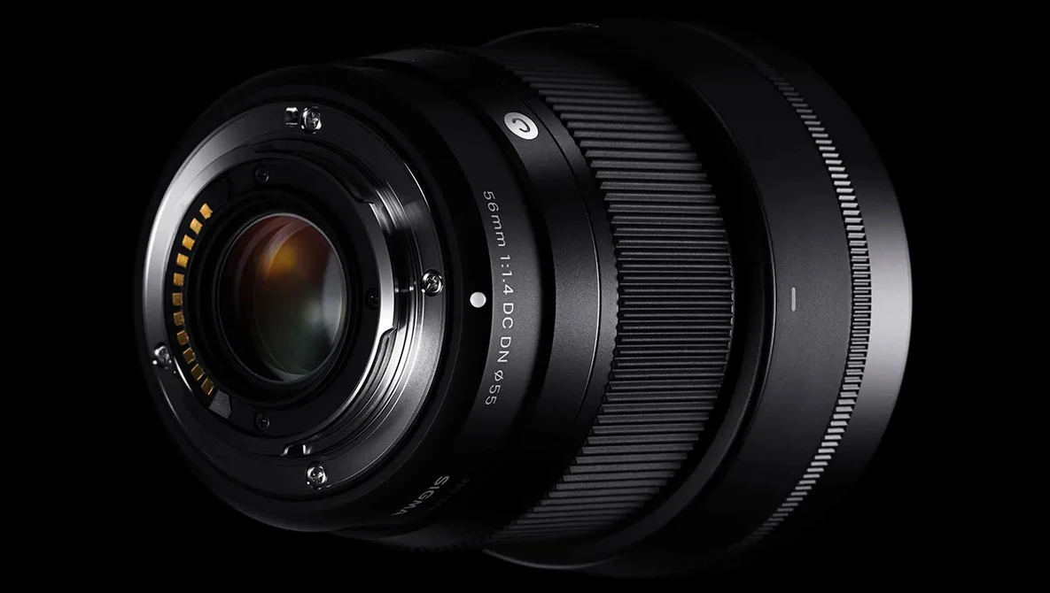 Three black camera lenses arranged in a row against a black background, showing their front glass elements and focusing rings.