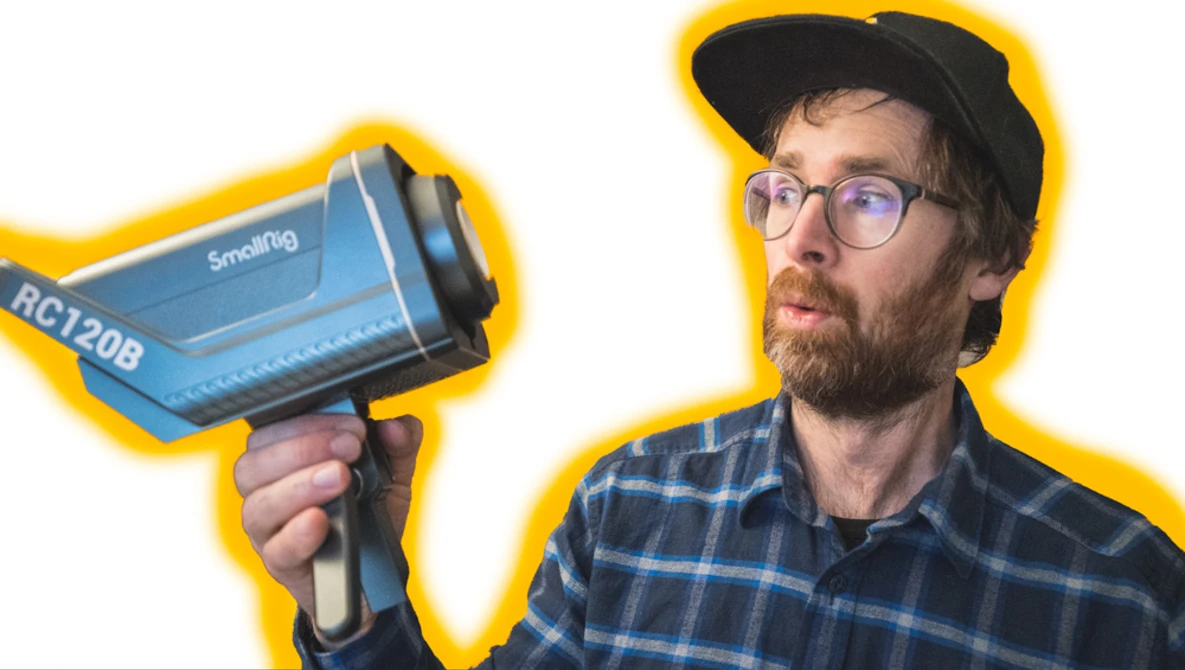 Photographer holding a blue thermal imaging camera with yellow border outline.