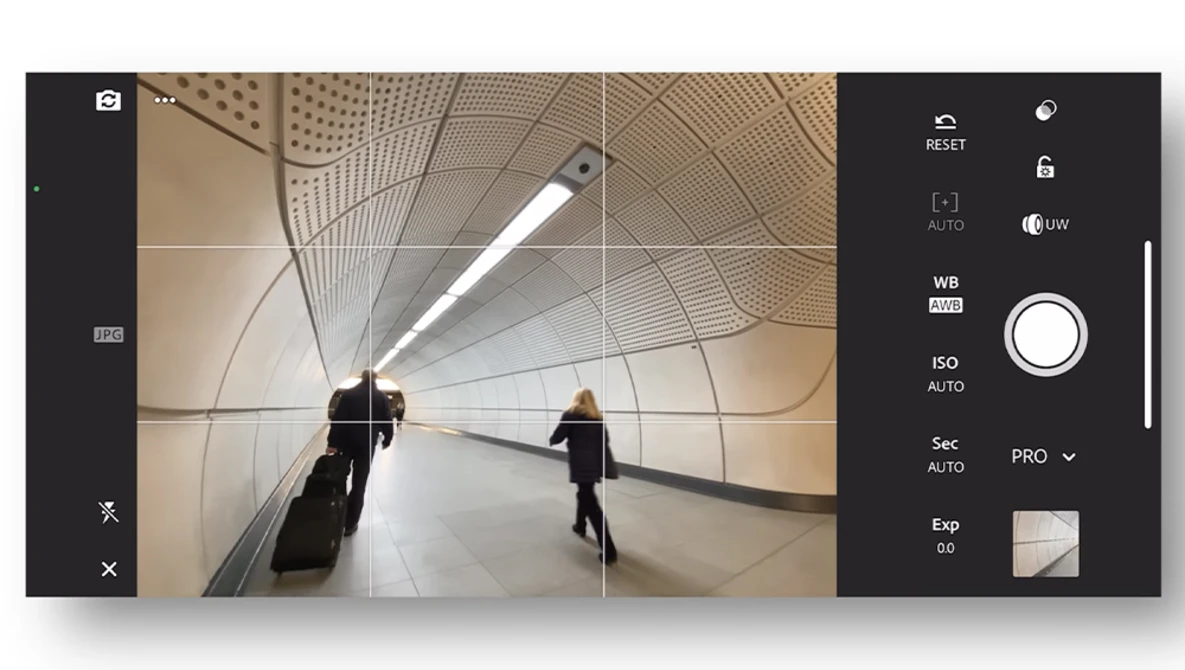 Screenshot of a mobile camera app interface showing a tunnel scene with two people and geometric architectural patterns.