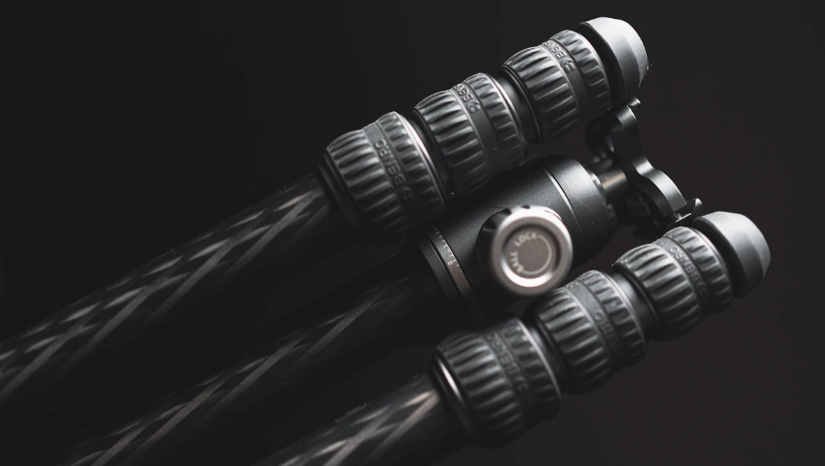 Three professional cinema lenses arranged against a black background with dramatic lighting.