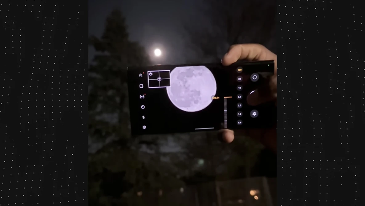 Smartphone displaying night sky photography app with moon capture overlay and manual camera controls visible on screen.