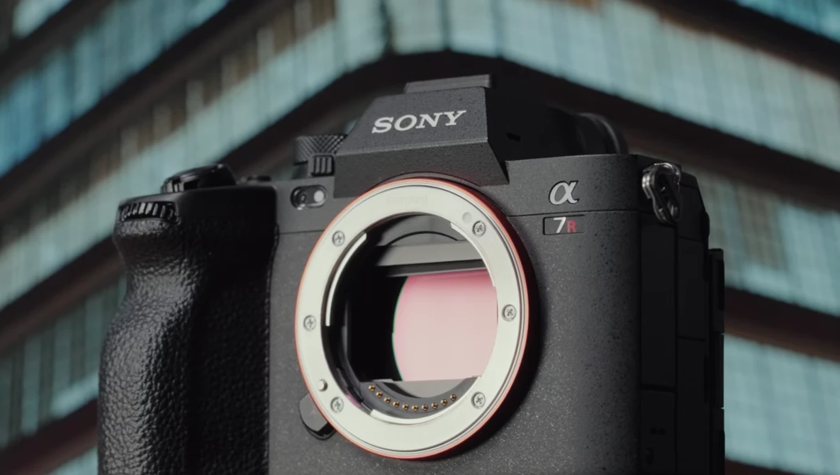 Sony Alpha mirrorless camera body with lens mount exposed against architectural background.