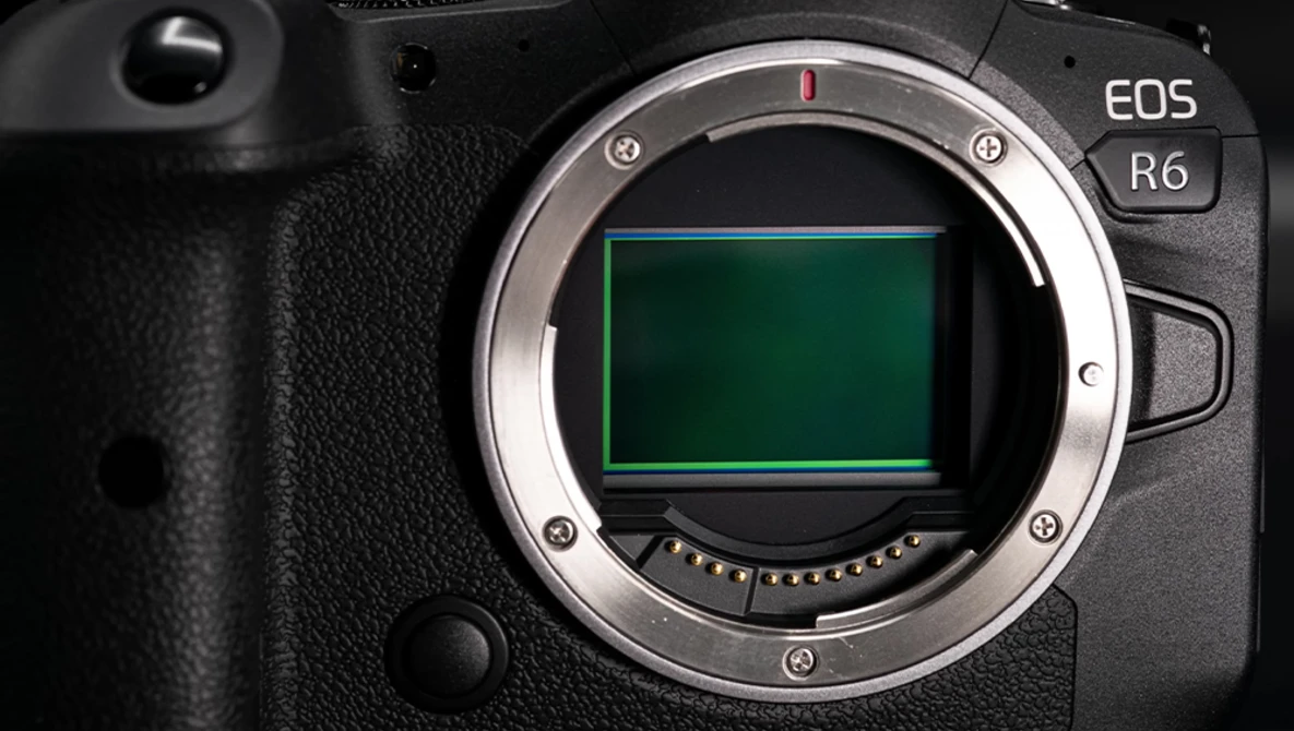 Canon EOS R6 mirrorless camera body with mount open, showing the sensor and contact pins.