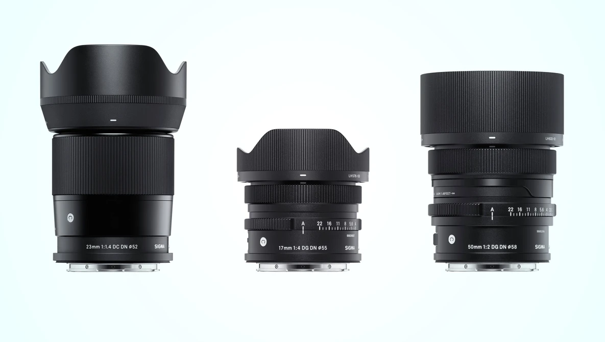 Three black camera lenses arranged in size progression from left to right against a light blue background.